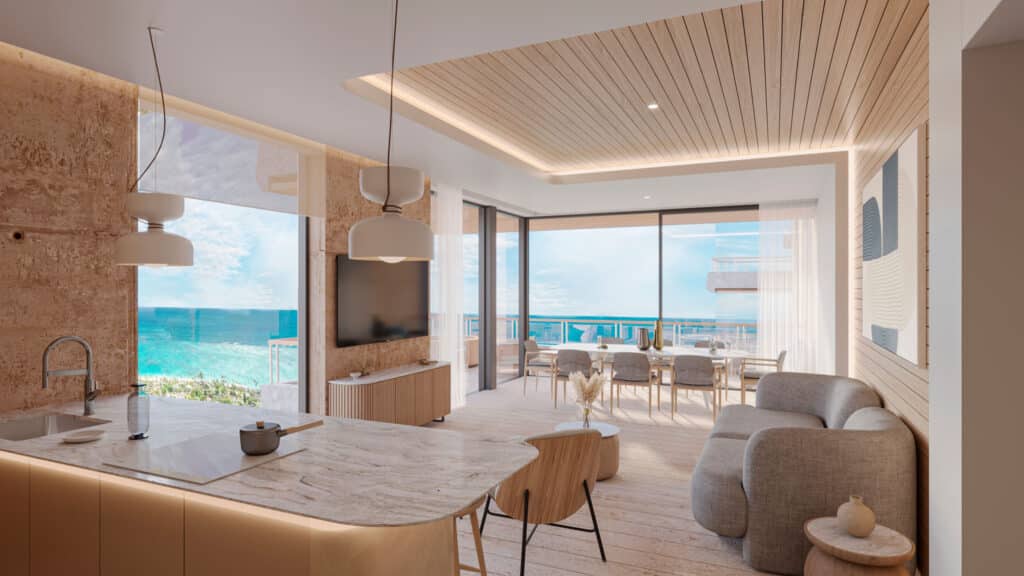 Interior view of a beachfront condo at BAO B in Puerto Morelos, featuring a modern living and dining area with large windows and ocean views.