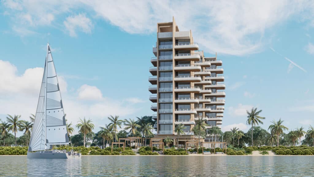 A modern beachfront condo at BAO A in Puerto Morelos, with spacious balconies and large glass windows, overlooking a waterway with a sailing boat and palm trees.