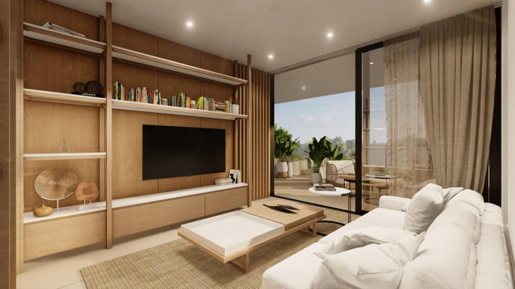 Living room with a white sofa, wooden shelving with books and decor, and a large sliding glass door leading to a balcony with plants in Playa del Carmen.