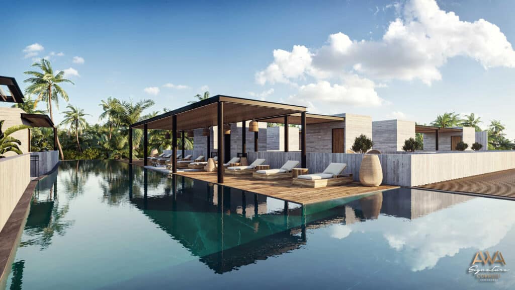 A spacious rooftop terrace with lounge chairs and shaded areas overlooks a pool, surrounded by modern white buildings and lush palm trees in Corasol, Playa del Carmen.