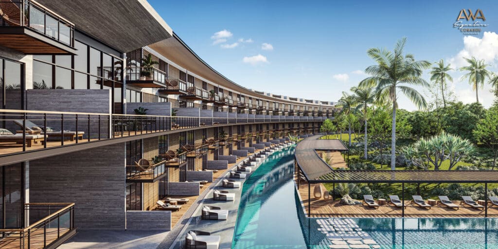 Aerial view of AWA Corasol PH D in Playa del Carmen's Corasol area, featuring a curved modern building with private balconies, an infinity pool, and lush tropical landscaping.