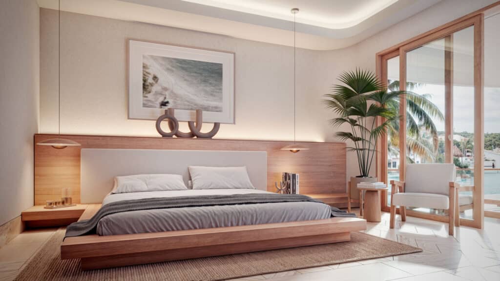 A modern bedroom at Gran Peninsula I in Puerto Aventuras Marina Front showcases light wood accents, a large bed, a comfortable armchair, and floor-to-ceiling windows with a view of palm trees and the marina.