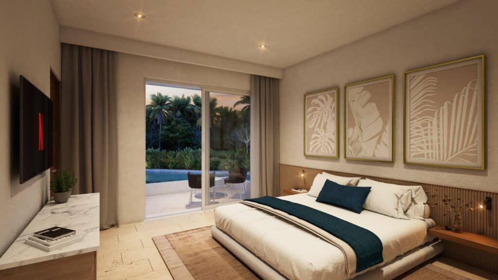 A bedroom in Marina Aqua A-201, Puerto Aventuras, featuring a large bed, artwork above, a sliding glass door opening to a balcony with a view of greenery and a pool.