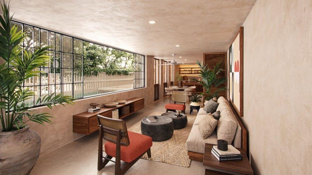 A spacious living area in Qanaai Nah 101 in Santa Ana, Merida, featuring a large window, modern furniture, potted plants, and warm neutral tones.