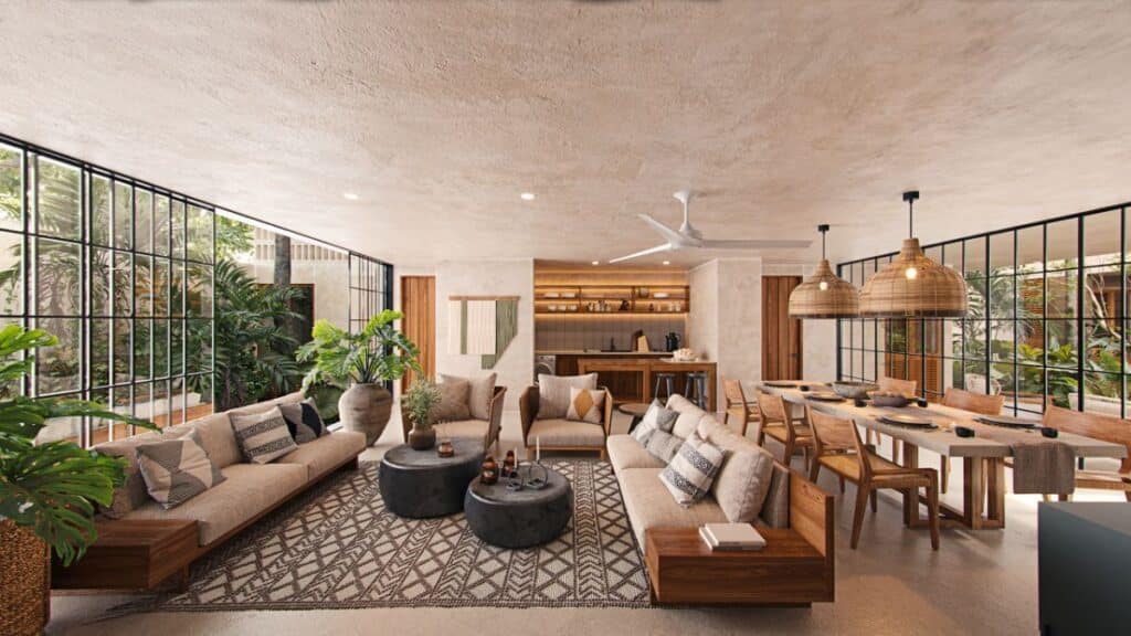 Interior view of a spacious living and dining area at Qanaai Nah 101 in Santa Ana, Merida, featuring large windows with lush greenery outside, wooden furniture, and neutral tones.