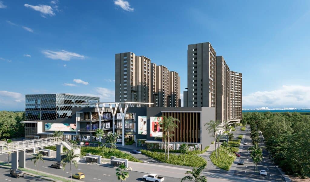 A modern multi-story residential building in Manglar Cumbres L, Cancun, situated in Colosio Cancun, with a commercial area in the foreground and a blue sky overhead.