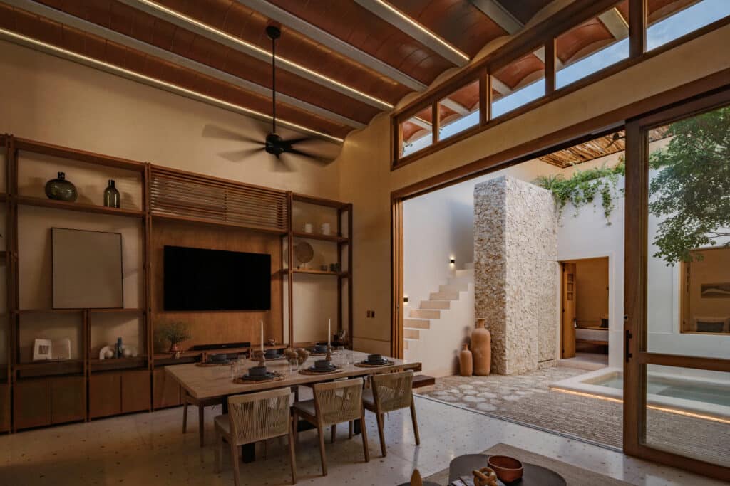 Interior view of Casa Caracol in Merida's Centro Merida, featuring a high wooden ceiling, open space, and a small indoor pool visible through the open doorway.