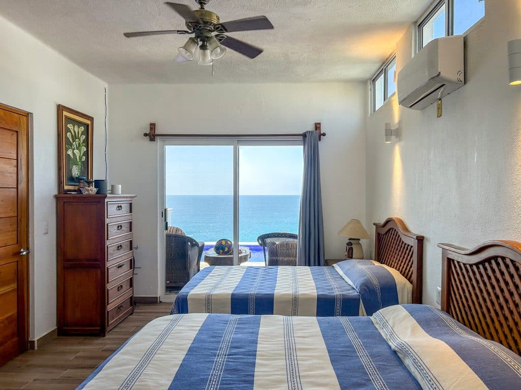 Bedroom with , wooden furniture, ocean view through sliding glass door, Casa Salchi in Huatulco