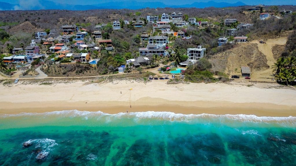 Casa Salchi in Huatulco, with houses overlooking Playa Salchi, features a beachfront view with sand and ocean waves