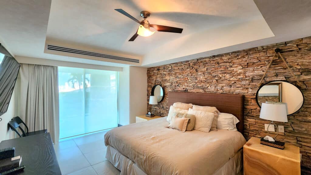 Interior of Villa Alejandra Garden with stone wall and balcony in Acapulco