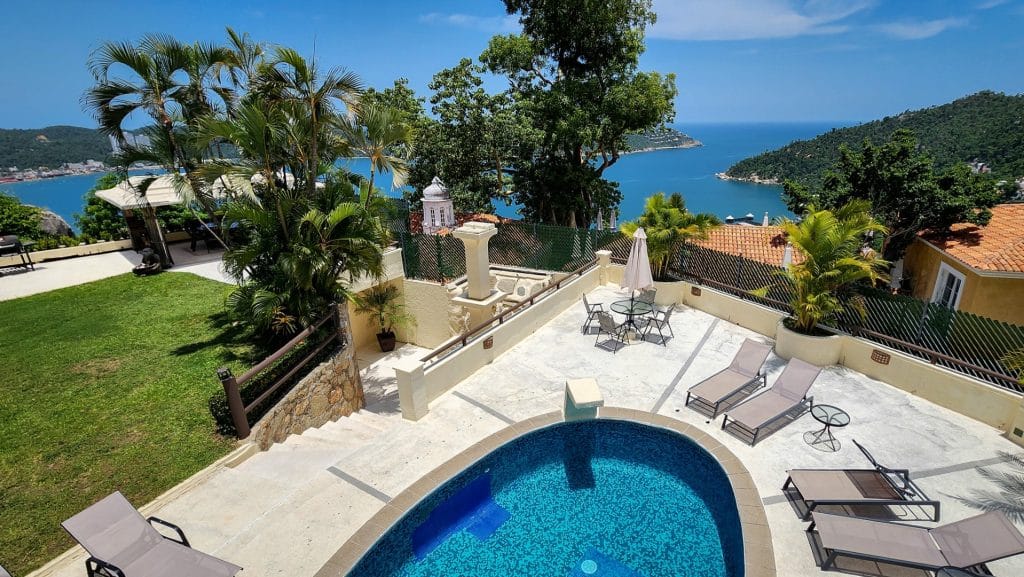 Lomas Del Marques House in Acapulco with a pool, terrace, lounge chairs, and ocean views surrounded by lush greenery