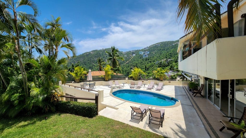 Lomas Del Marques House in Acapulco with a swimming pool, surrounded by lush greenery and mountain views