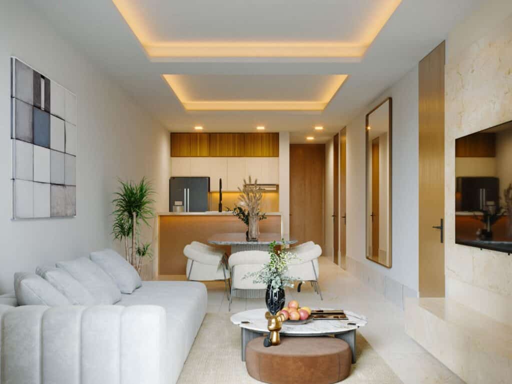 Modern living room with white sofa, round dining table, and kitchen in Distrito Zen Cancun 407