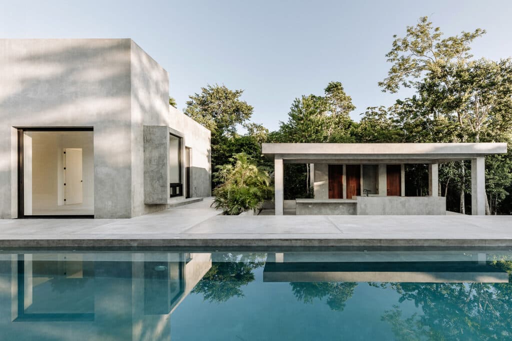 A modern concrete-designed house with a swimming pool, located in Villa Amanai, Tulum, in the Rancho Viejo area.