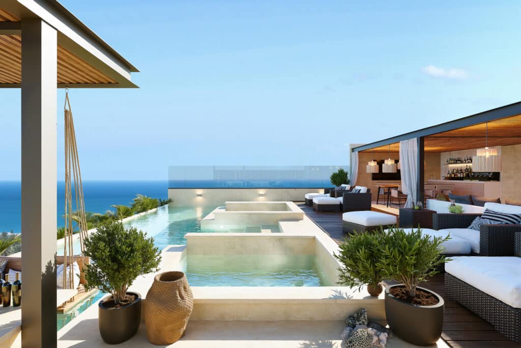 Penthouse at Petrus in Playa del Carmen featuring an outdoor pool, lounge area, and ocean views in Playa Centro.