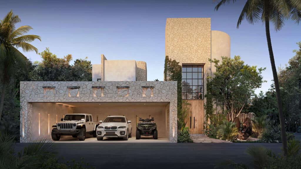 A modern house Satori Kanso in Tulum's Region 8, featuring a stone façade, large glass windows, a garage with three vehicles, and lush greenery around.