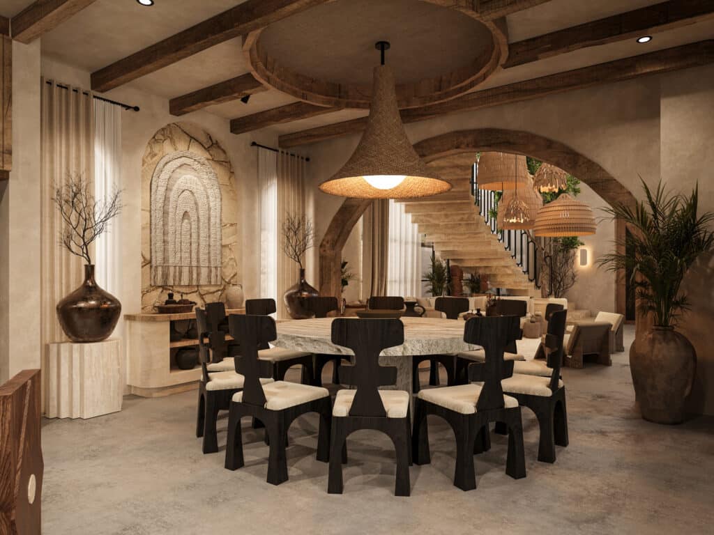 Interior view of a spacious living area at Satori Kanso in Tulum, featuring a large dining table, natural wood accents, and elegant decor with lush plants.