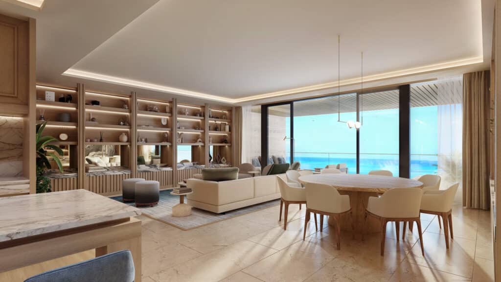 Interior view of a beachfront condo at Marietta Residences in Isla Mujeres, featuring a modern living and dining area with large windows overlooking the ocean.