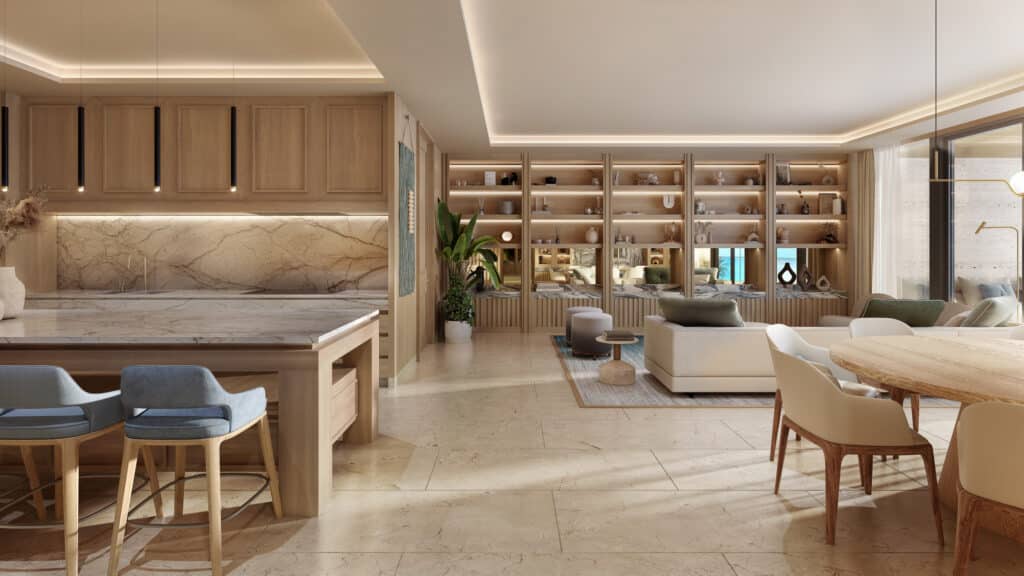 Interior view of Marietta Residences 506 in Isla Mujeres, showcasing a modern, open-concept living area with beige marble floors, wooden accents, built-in shelving, and large windows.
