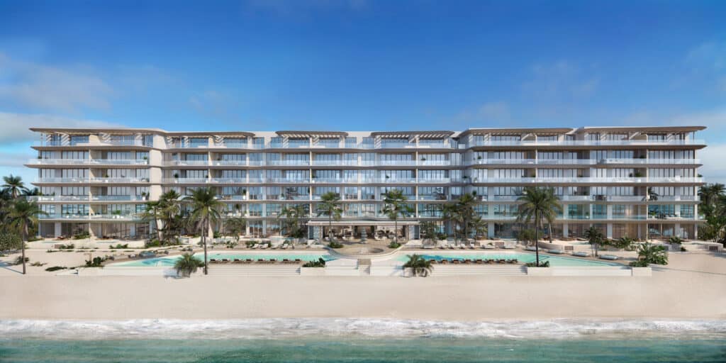 Front view of Marietta Residences a beachfront development in Isla Mujeres, showcasing its modern design and pool area on the sandy shoreline.