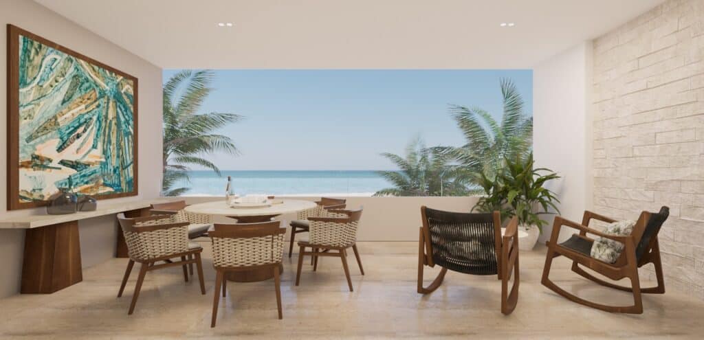 A dining area in Madeira Vida De Mar, Chicxulub, with a large window offering a view of the beachfront, wooden chairs, a rocking chair, and tropical plants.
