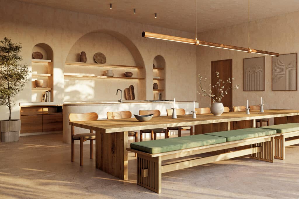A spacious dining area in Muuyal in Tulum features a long wooden table with green-cushioned benches, minimalist wall art, and natural sunlight filtering through.
