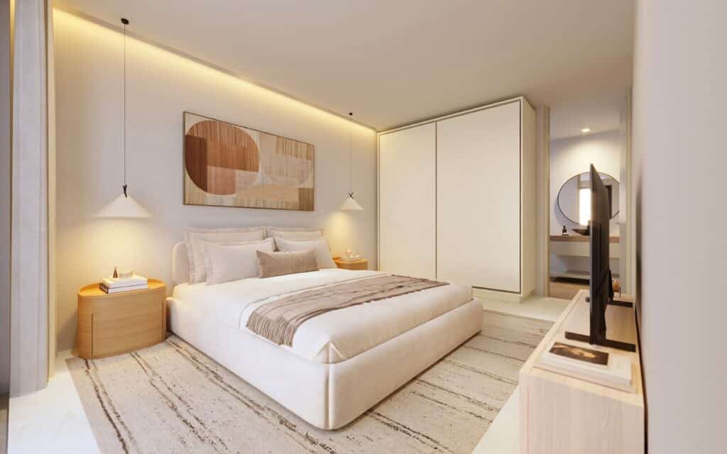 Modern bedroom with a white upholstered bed, abstract art above, wooden bedside tables, and a wardrobe in Playa del Carmen's.