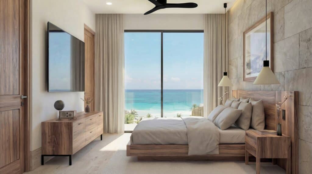 Modern bedroom with a large glass window overlooking the ocean, wooden furniture, and beige walls at Luna Azul 101 in Bahia Xcacel, Puerto Aventuras.