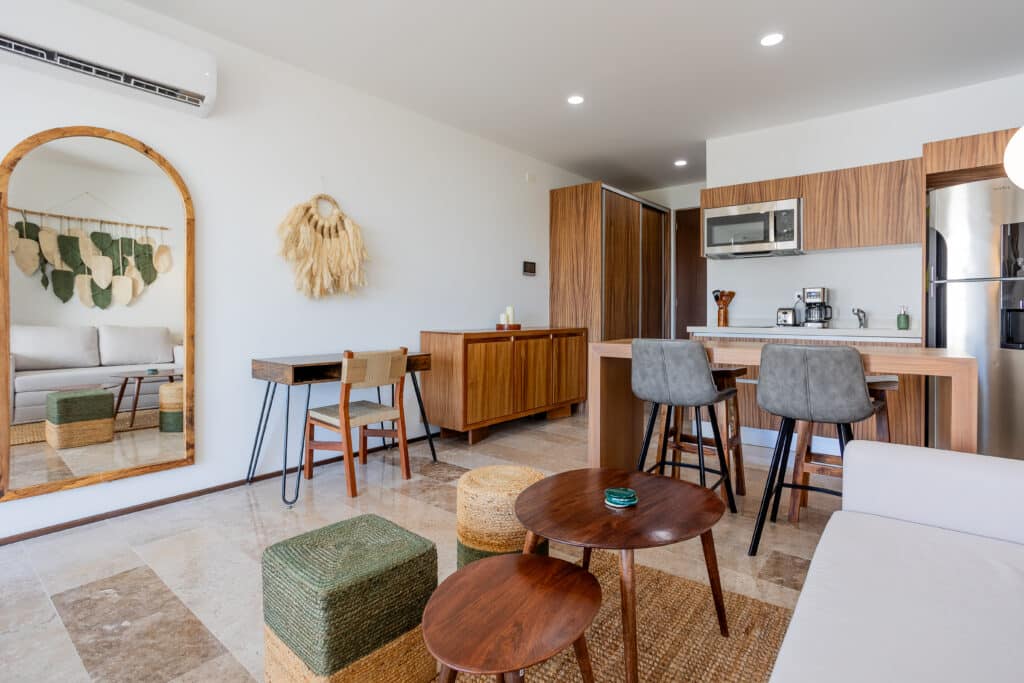 Interior view of a studio with a modern kitchen, dining area, and decorative elements at My Menesse 407 Studio in Playa Centro, Playa del Carmen.