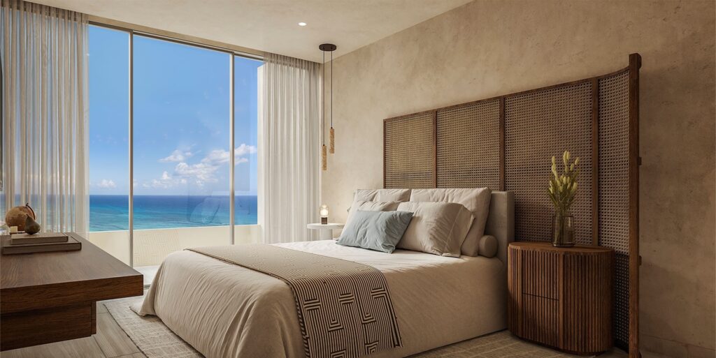 Bedroom with large floor-to-ceiling window showing ocean view, neutral decor, beige walls, and wooden accents at Viceroy Residences in Playa del Carmen.
