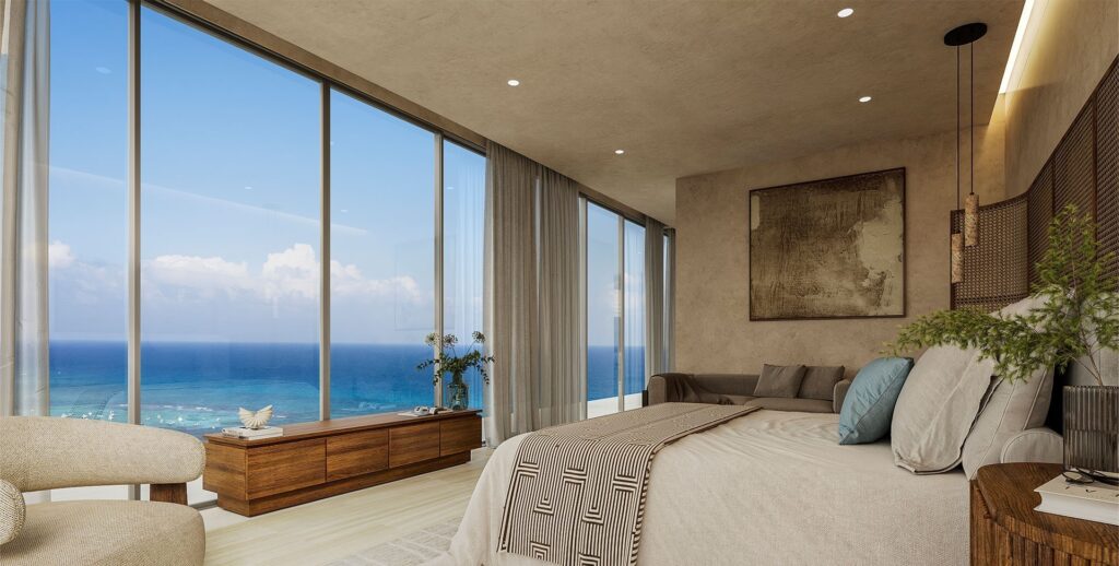 Modern bedroom with floor-to-ceiling windows offering ocean views, neutral decor, and minimalist furniture at Viceroy Residences in Playa del Carmen.